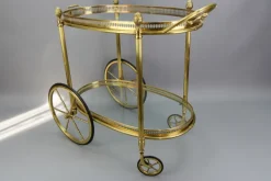 Pamono Mid-Century Modern 2-Tier Brass and Glass Bar Cart in the style of Maison Baguès, 1950s Online