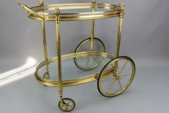 Pamono Mid-Century Modern 2-Tier Brass and Glass Bar Cart in the style of Maison Baguès, 1950s Online